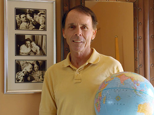 Martin Gray with family photos on wall