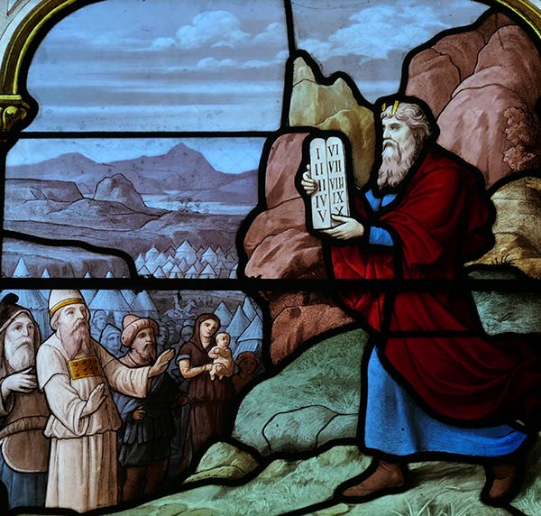 Moses ascends from Mt. Sinai carrying the Tablet with the Ten Commandments. Photograph of stained glass window at Church of Saint Aignan, Chartres, France.