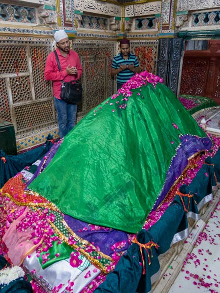 Pilgrim praying inside shrine of Nizamuddin Dargah, New Delhi