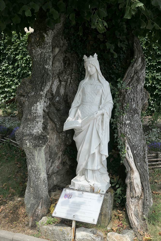 Basilique Notre-Dame de Sion, statue of Mary, inside of tree next to Basilica