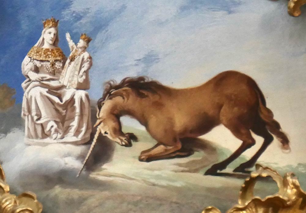 Ettal Abbey, Ettal. Painting of unicorn bowing to statue of Mary and Jesus, on cathedral ceiling.